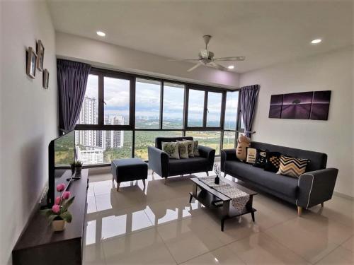 a living room with a couch and a table at Iskandar Residences 2BR 5pax 5 mins Legoland Wi-Fi Sky Pool 360 in Nusajaya