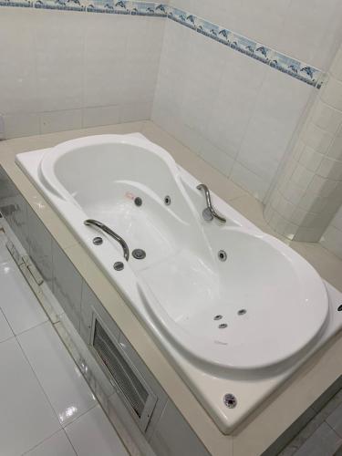 a white bath tub in a white bathroom at Hotel Mirante B in Euclides da Cunha