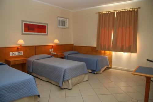 En eller flere senger på et rom på Jaguary Hotel Sumaré