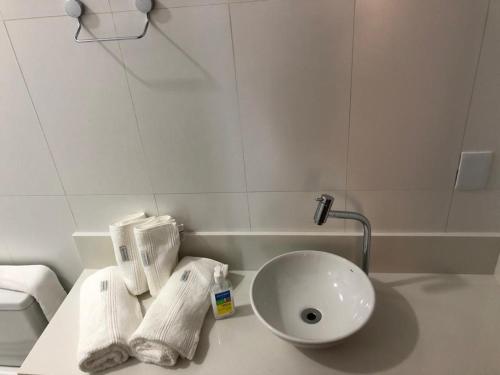a bathroom with a sink and towels on a counter at Almada Studio 77 in Cunha