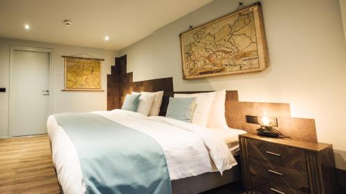 a bedroom with a large bed and a map on the wall at Oldschool Hotel in Winterswijk