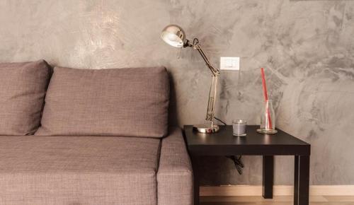 a lamp sitting on a table next to a bed at Guest House Roma in Rome