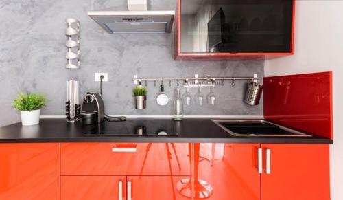 a kitchen with a sink and red cabinets at Guest House Roma in Rome