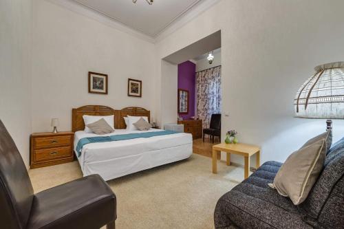 a bedroom with a bed and a couch at House 52 Boutique Hotel in Tbilisi City