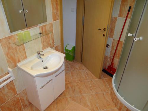 a bathroom with a sink and a shower at Apartments Sanja in Baška