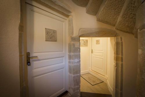 a hallway with a white door in a room at Le Cara Alya 1G in Beaune