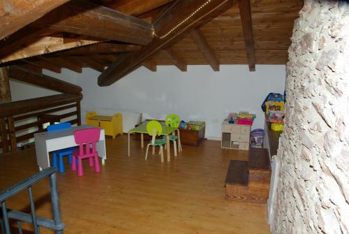 a living room with colorful chairs and a table at Agriturismo Cervano in Toscolano Maderno