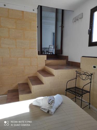 a pillow on a bed in a room with stairs at Le Dimore Di Gianni in Favignana