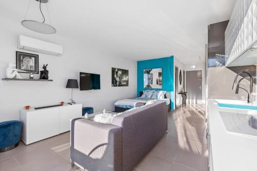 - un salon avec un canapé et un lit dans une chambre dans l'établissement Blue Dream Heliopolis, au Cap d'Agde