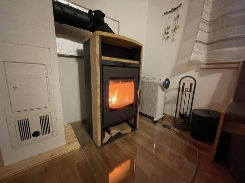 a woodburning stove in a living room with a fireplace at Chalet Falkenstein in Steyrling
