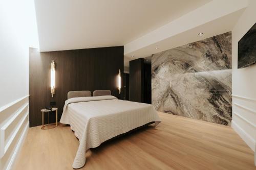 a bedroom with a bed and a large painting on the wall at Albergo Italia in Matera