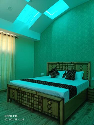 a bedroom with a large bed with green walls at Oak Retreat Huts in Shimla