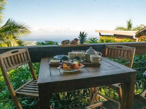 a table with a tray of food on a balcony at KAZ ORÈA in Saint-Leu