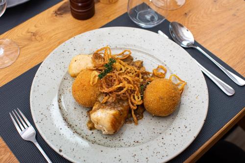 a plate of food with spaghetti on a table at Kozjanski dvor in Podčetrtek