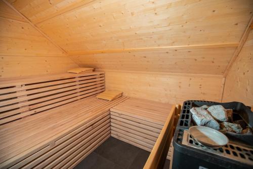 a wooden sauna with two trunks and a stove at Kozjanski dvor in Podčetrtek