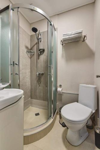 a bathroom with a shower and a toilet and a sink at House 52 Boutique Hotel in Tbilisi City