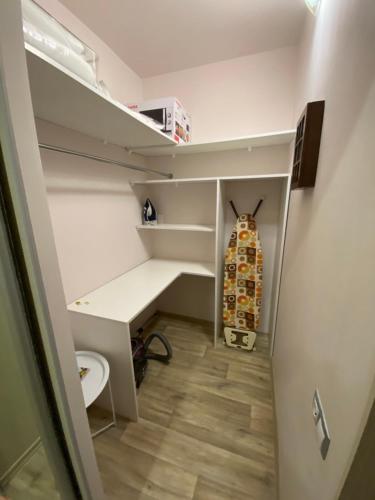 a closet with a desk and a surfboard in it at Larionov Great Apartment (1 room) in Tiraspol
