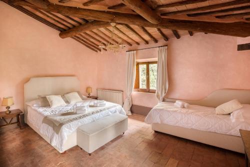 a bedroom with two beds and a window at Castello di Bossi in Castelnuovo Berardenga