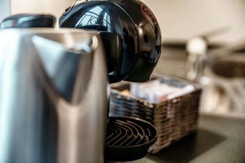 affeepot is hooked up to a coffee maker at Salorino Apartments by Quokka 360 - with a view of nature in Mendrisio