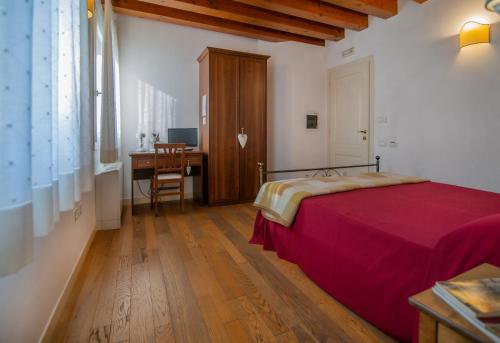 a bedroom with a bed and a desk and a table at Ca' Dei Molini in Gruaro