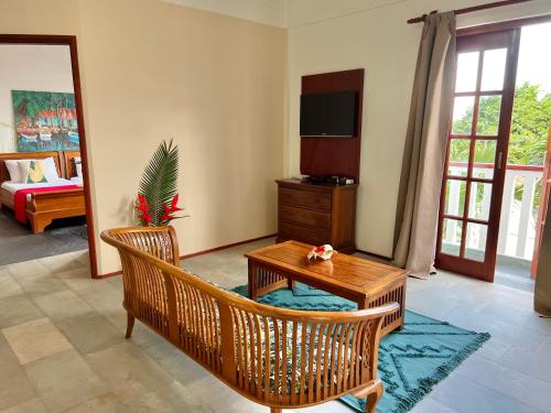 a living room with a table and chairs and a television at Hilltop Boutique Hotel in Victoria