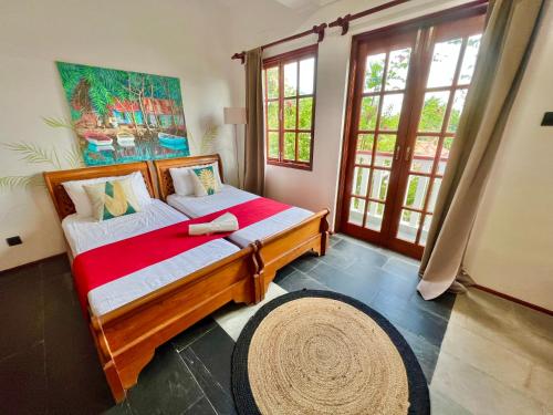 a bedroom with a bed in a room with windows at Hilltop Boutique Hotel in Victoria