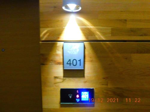 a clock on a wall with a light on it at Aparthotel Vučko Apartment Farra in Jahorina