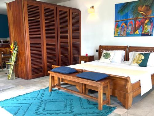 a bedroom with a bed with blue pillows on it at Hilltop Boutique Hotel in Victoria