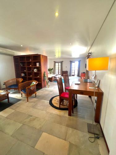 a large living room with a desk and chairs at Hilltop Boutique Hotel in Victoria