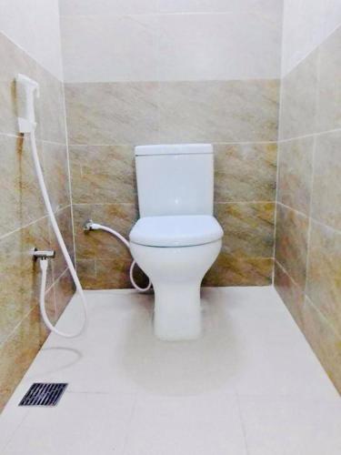 a bathroom with a white toilet in a room at Hotel Seven Star in Dhaka