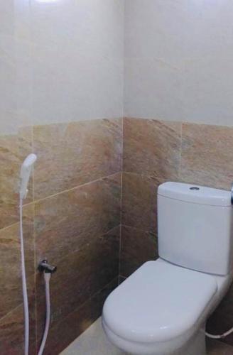 a bathroom with a white toilet in a room at Hotel Seven Star in Dhaka