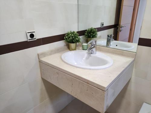 a bathroom with a sink and a mirror at APARTMENT LA CALA DESIGN & ALAMAR SEA WIEW. in La Cala de Mijas