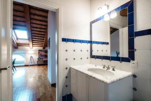 a bathroom with a sink and a mirror at Salorino Apartments by Quokka 360 - with a view of nature in Mendrisio