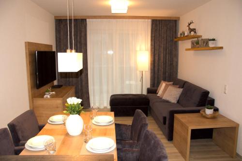 a living room with a table and a couch at Residenz Grafenmatt Feldberg in Feldberg