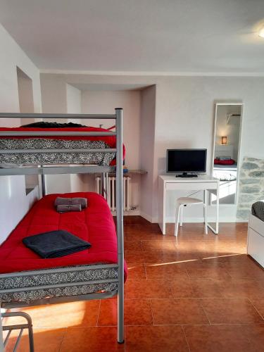 a bedroom with two bunk beds and a desk at STONE in Crodo