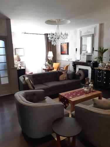 un salon avec un canapé et une table dans l'établissement La Glycine Blanche, à Pomas