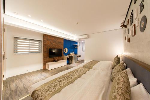 a large bed in a room with a television at 台南安平民宿幸福拾光 in Tainan