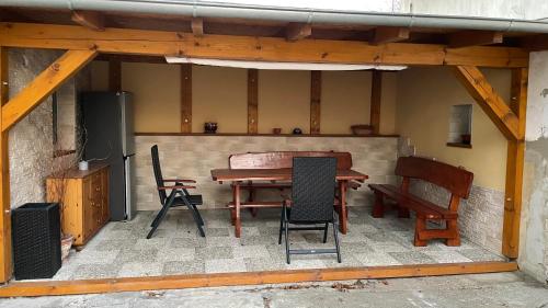 a patio with a table and chairs and a speaker at Penzion Hedvika in Kravaře