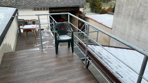 a balcony with a chair and a table on it at Penzion Hedvika in Kravaře