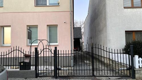 a black fence in front of a building at Penzion Hedvika in Kravaře