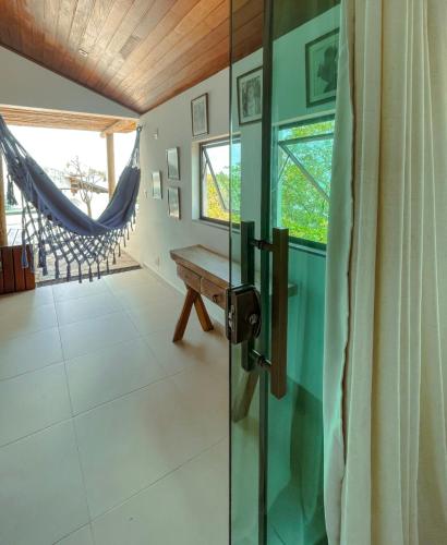 a room with a sliding glass door with a wooden ceiling at Encanto das Flores in Pipa