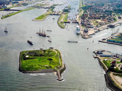 an island in the middle of a river with boats at Eco Hotel Plantage Rococo in Velsen-Zuid
