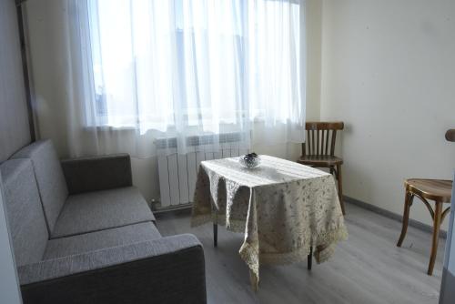 a living room with a table and a chair at Cosy Home in Gyumri
