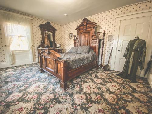 a bedroom with a wooden bed in a room at Lizzie Borden House in Fall River