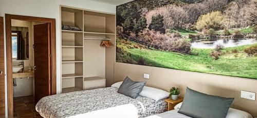 ein Schlafzimmer mit einem Bett und einem Gemälde an der Wand in der Unterkunft Casas Rurales en Peguerinos (P.N. del Guadarrama) in Peguerinos