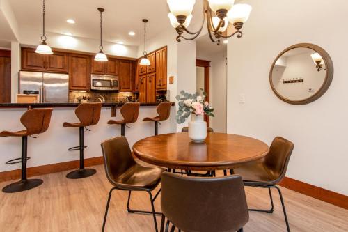 a dining room with a table and chairs and a mirror at Modern Riverstone Condo with Grand Deck - Steps to Shops, Restaurants, Trails and River in Coeur d'Alene