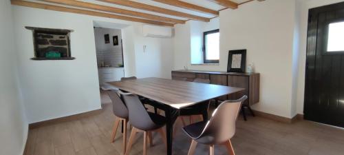 a dining room with a wooden table and chairs at Pomar das Oliveiras - Private Swimming pool - Free EV Chrg - Pet Friendly in Carvalhal Cimeiro