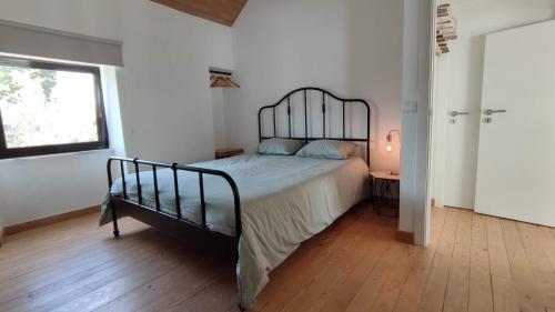 a bedroom with a bed with a metal frame at Pomar das Oliveiras - Private Swimming pool - Free EV Chrg - Pet Friendly in Carvalhal Cimeiro