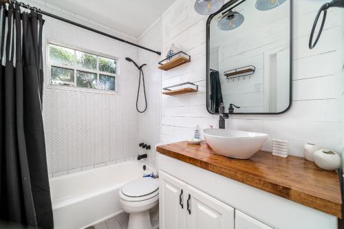a bathroom with a sink and a toilet and a mirror at Pool Home in Hollywood