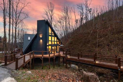 a tiny house on a deck with a bridge at Night Owl cabin in Gatlinburg